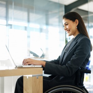 Businesswoman Sitting in a Wheelchair Working on Her Laptop